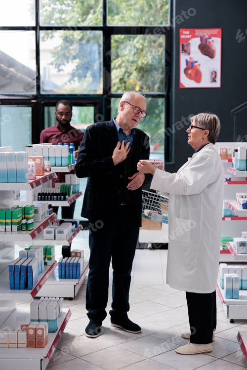 Preview: Senior specialist explaining cardiology pills treatment to old man customer