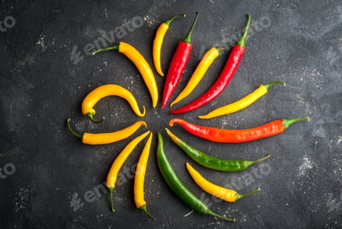 Preview: Variety of chili peppers. Red, green and yellow chili pepper on dark background top view