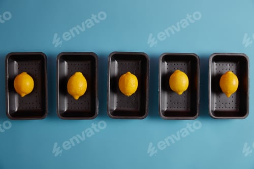 Preview: Picked ripe fresh lemons on trays ready to be added to some dishes for sour flavor, making refreshin