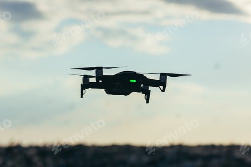 Preview: Drone silhouette on sky background with sunset