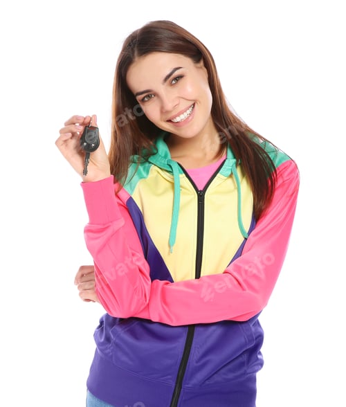 Preview: Happy young woman with car key on white background. Getting driving license