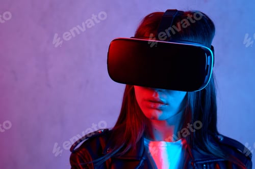Preview: Young girl using virtual reality helmet while wearing a jacket