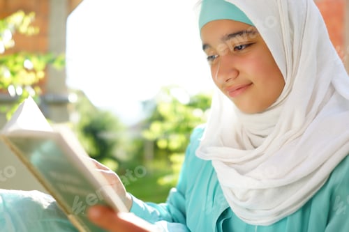 Preview: Beautiful Muslim Girl Reading Book With Hijab And Smiling