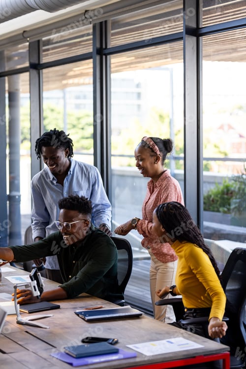 Preview: In office, team collaborating using digital devices, sharing ideas enthusiastically