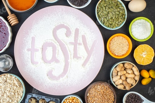 Preview: top view tasty written flour with nuts seeds cereals raisins and jelly on a dark background cake