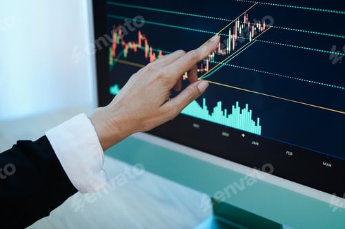 Preview: Trader woman studying stock market at home - Focus on hand
