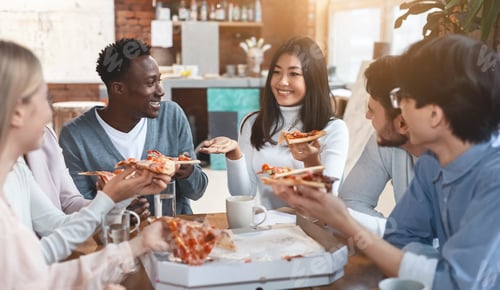 Preview: Cheerful colleagues eating take away food in office
