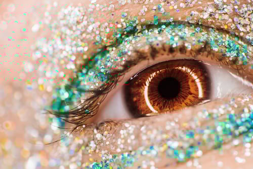 Preview: Macro brown female eye with glitter eyeshadow, colorful sparks, crystals