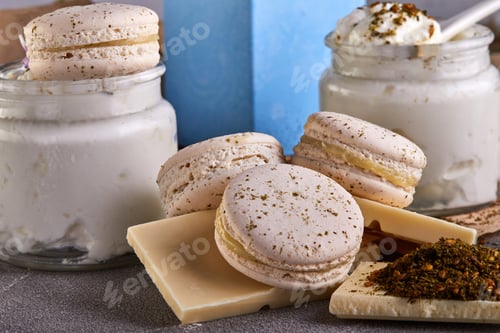 Preview: Wooden cutting board topped with macarons , chocolate , yogurt and grapes