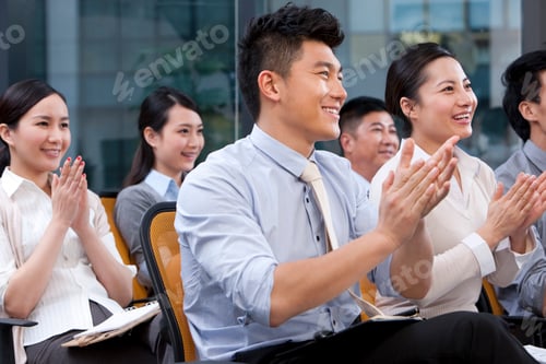 Preview: Chinese businesspeople clapping at a conference