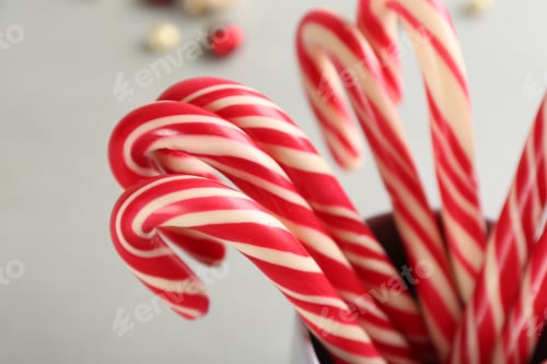 Preview: Sweet Christmas candy canes on light background, closeup