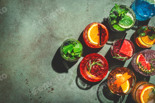 Preview: Cocktails set on rusty green bar counter, top view. Mixology concept. Assortment of alcohol drinks