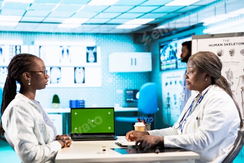 Preview: Doctor and patient discuss about health care recovery next to mockup screen