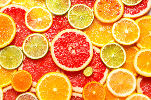 Preview: Slices of fresh citrus fruits as background, top view