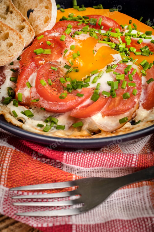 Preview: Homemade breakfast fried egg with tomato.