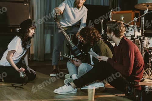 Preview: music band sitting on floor and creating text for song together