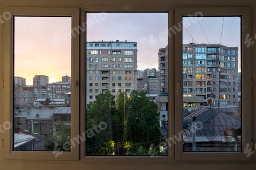 Preview: view through glass balcony on evening city
