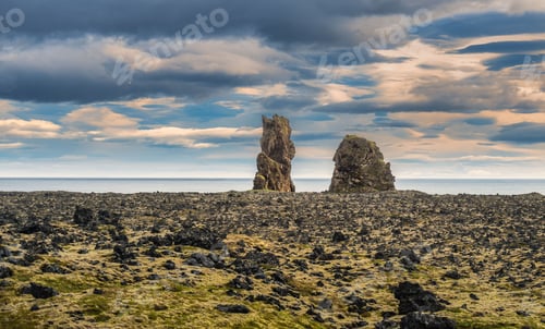 Preview: Rugged volcanic landscape with sea stacks in Iceland.
