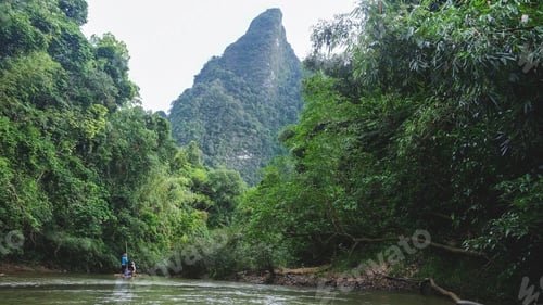 Preview: People riding on bamboo raft along the river and the greenery rainforest