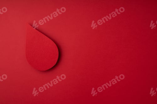 Preview: World donor day concept with paper red drop on red background