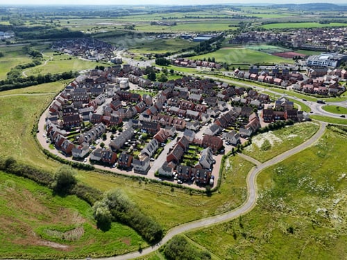 Preview: Aerial view of a residential neighborhood surrounded by green fields in Berryfields, England, UK