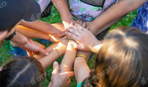 Preview: The children put their hands together. Selective focus.