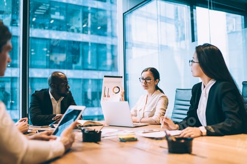 Preview: Diverse associates looking at diagram in office space