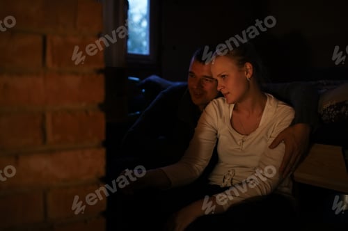 Preview: Couple Embracing in Dark Home Setting at Night
