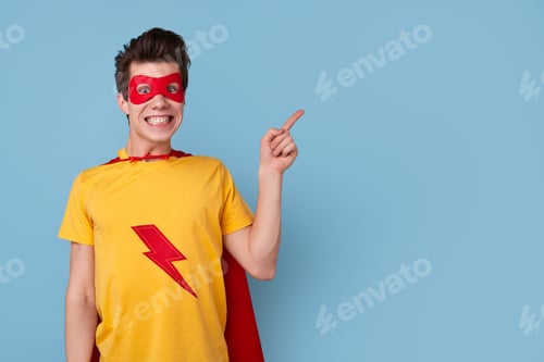 Preview: Cheerful superhero man pointing aside
