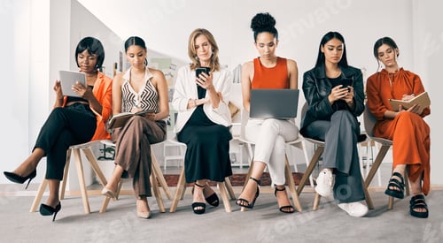 Preview: Shot of a group of businesswomen sitting in a row in an office at work