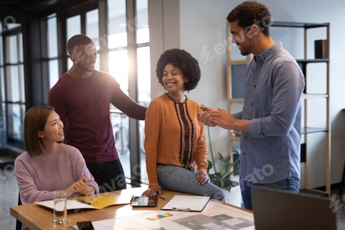 Preview: Diverse group of business people working in creative office