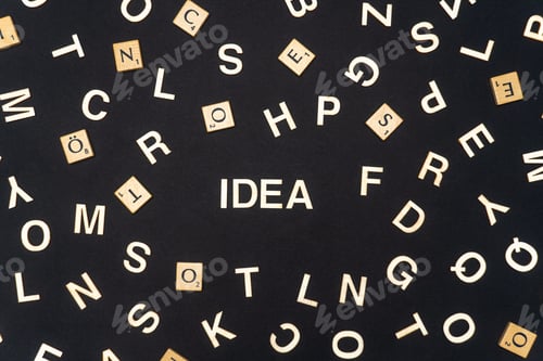 Preview: IDEA word written on dark paper background. IDEA text for your concepts