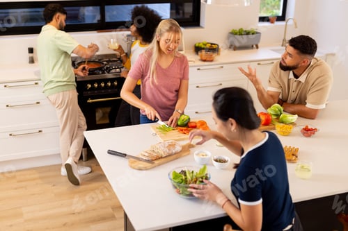 Preview: Friends preparing meal together, chopping vegetables and making salad in kitchen