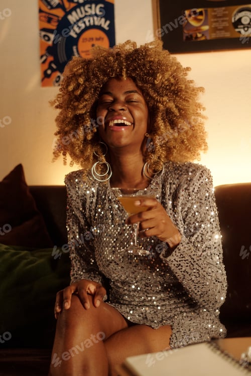 Preview: Laughing Woman Holding Drink and Wearing Sequin Dress