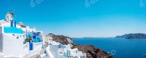 Preview: White churches an blue domes by the ocean of Oia Santorini Greece, traditional Greek village