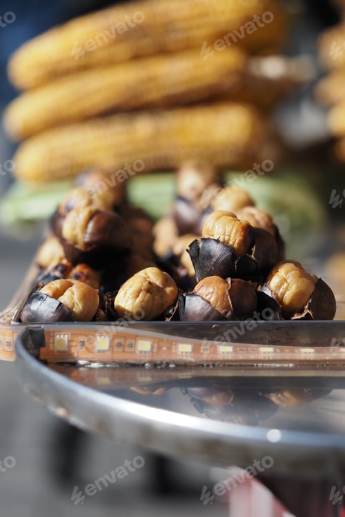 Preview: Grilled chestnuts and corn sold at street market in autumn
