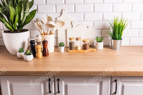 Preview: Beautiful kitchen background of a modern countertop with a set kitchen utensils, green plants