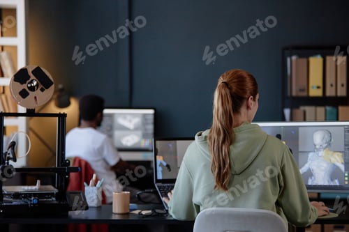 Preview: Individuals Working in Modern Office With Computer Screens