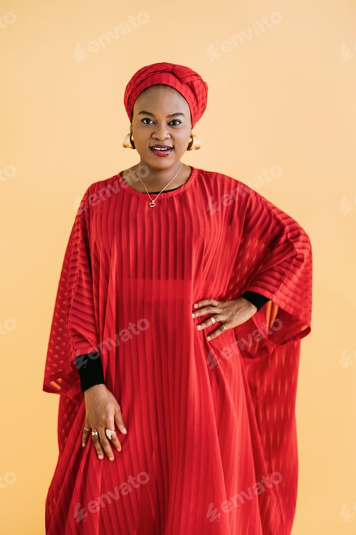 Preview: Women in traditional African style. Waist up studio shot of beautiful African woman in red dress