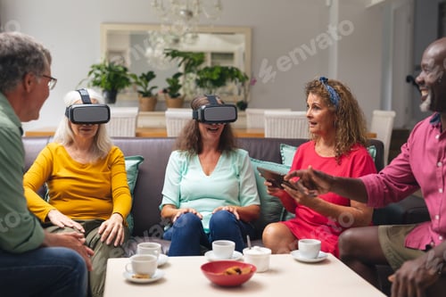 Preview: Multiracial senior woman and men with friends using vr headsets at home