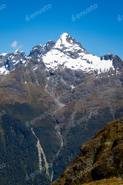 Preview: Snow-Capped Mountain Peak Under Blue Sky