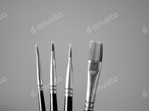 Preview: Black and white shot of four paint brushes of different sizes