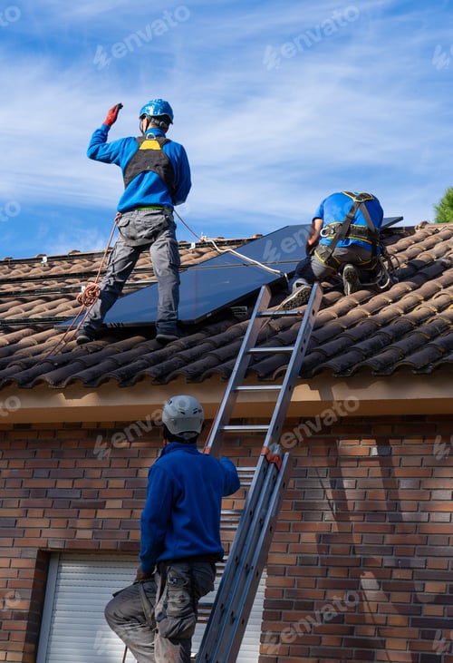 Preview: Workers installing solar panel on roof of residential building