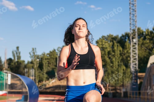 Preview: A female athlete warming up before running.