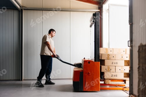 Preview: Man transporting boxes with forklift in a farm facility