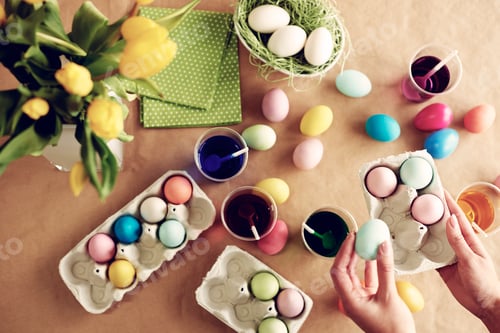 Preview: Human hands holding box of dyed eggs