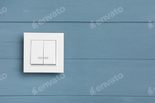Preview: White light switch on grey wooden background. Space for text