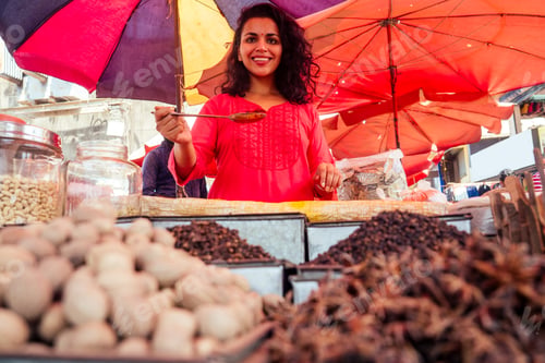 Preview: indian happy woman salling spices in bazaar in Goa