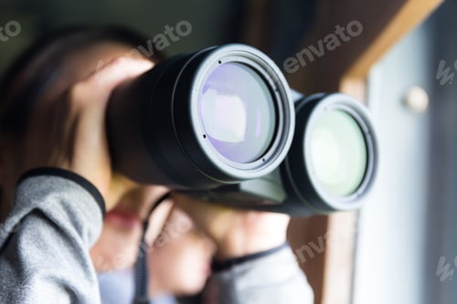 Preview: Asian woman looking though binocular