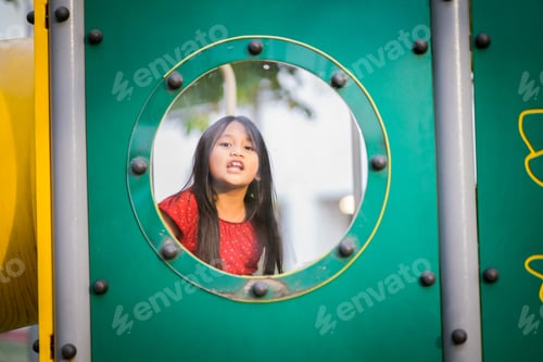 Preview: young girl with long hair at the playground window
